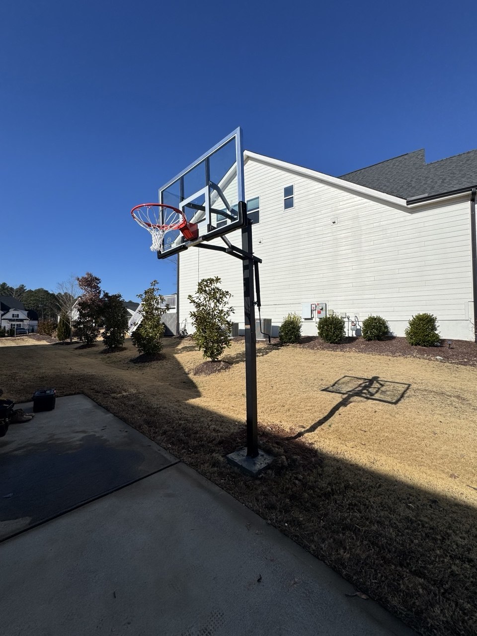 In-ground basketball hoop installed in concrete at Triangle NC home