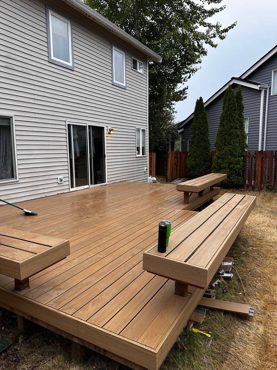 New composite deck with built-in bench seating installed by Holly Springs Handyman in Triangle NC