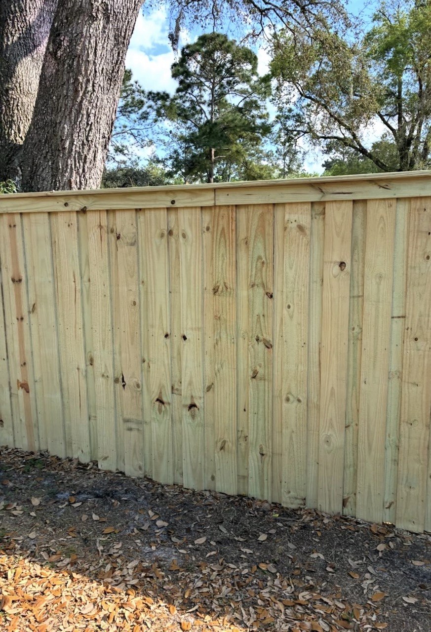 New pressure-treated wood privacy fence installed by Holly Springs Handyman in Triangle NC