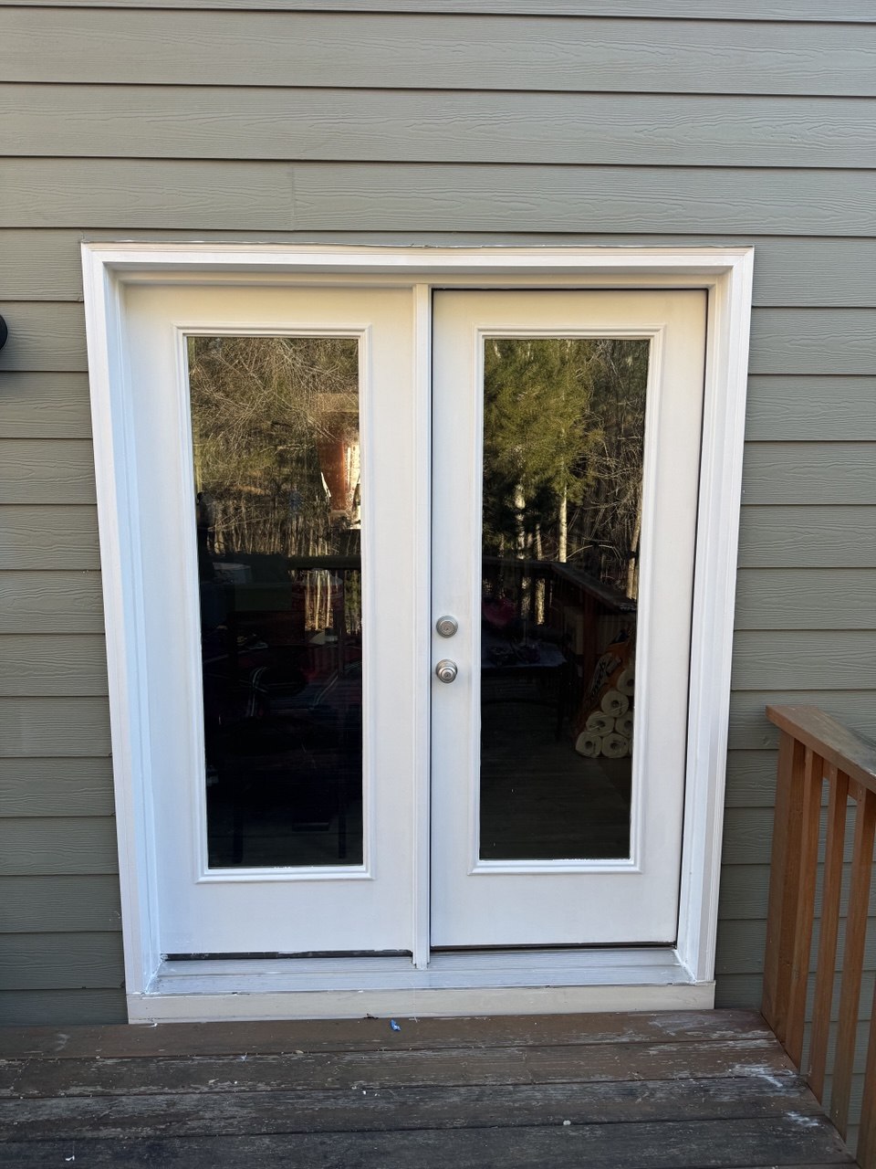 Exterior French double door with rotten frame and door restored and repainted white in Triangle NC home