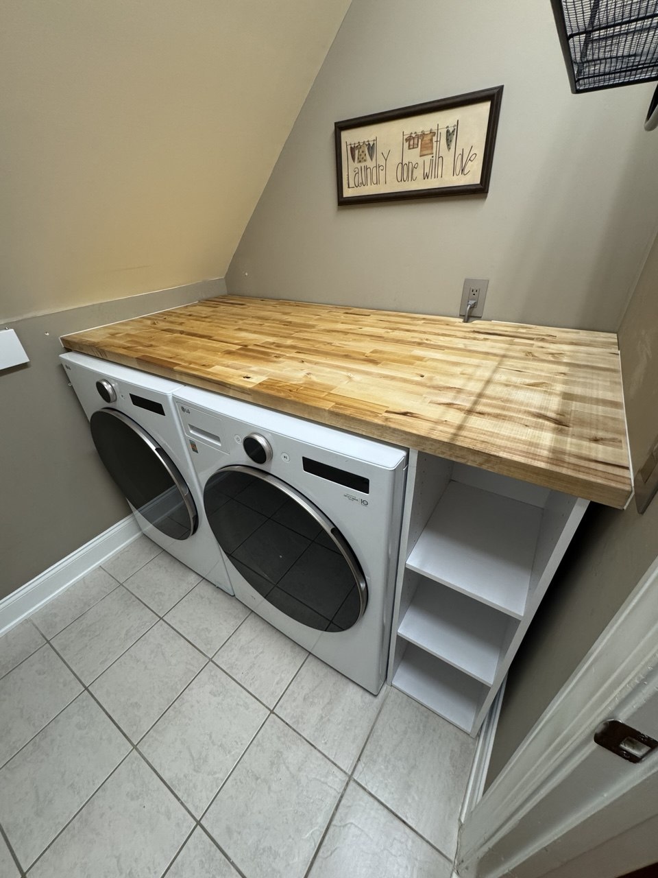 Custom butcher block countertop and built-in shelving unit in laundry room in Triangle NC home