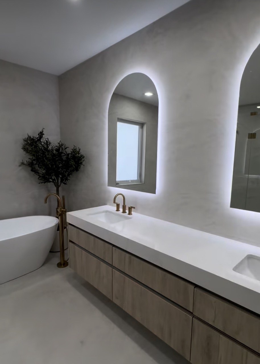 Luxury bathroom remodel with floating vanity, backlit mirror, and freestanding tub in Triangle NC