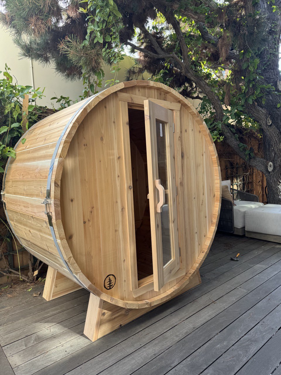 Cedar barrel sauna assembled on backyard deck in Triangle NC