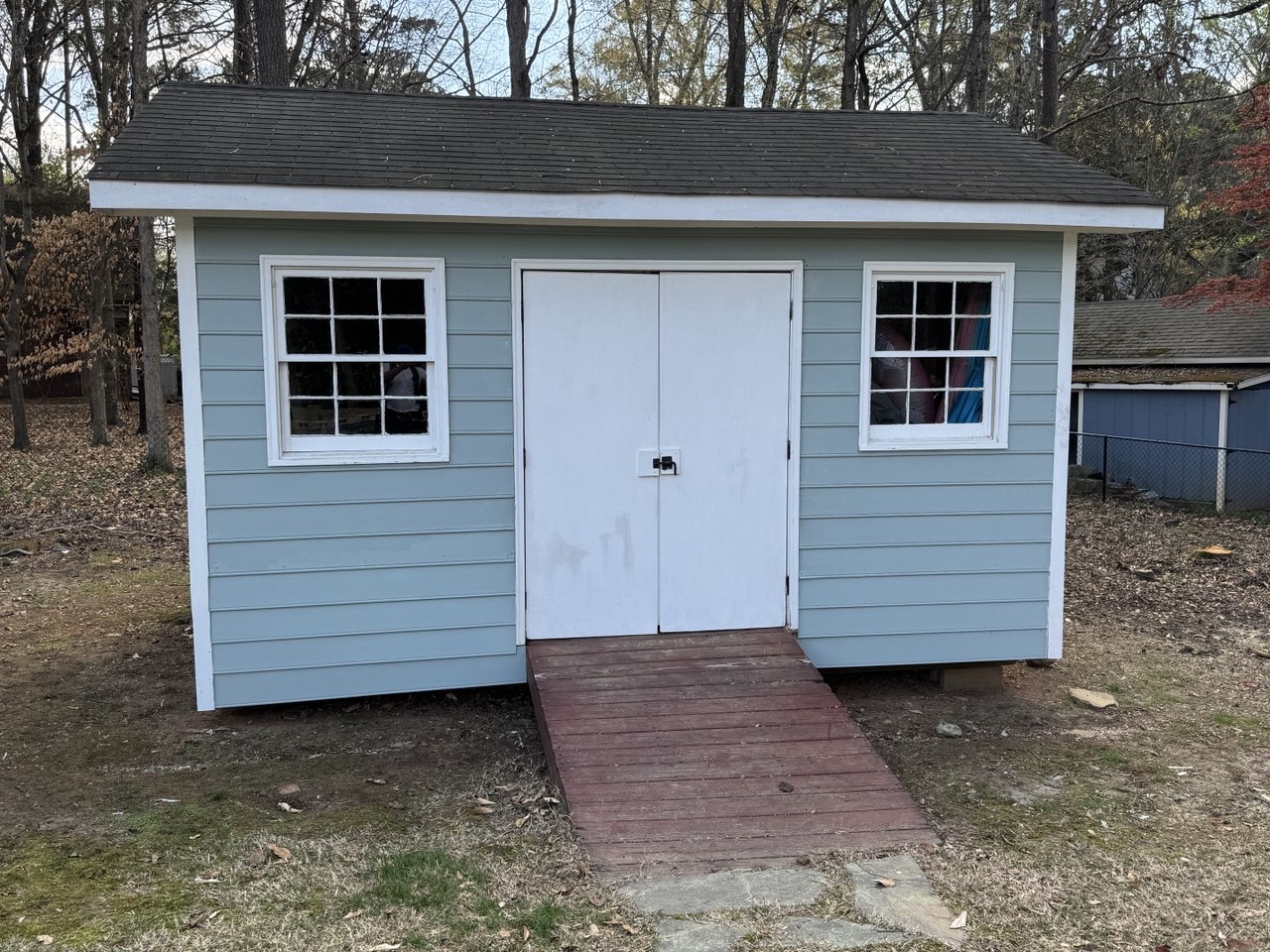 Exterior siding repair and paint — storage shed restored with new lap siding in Triangle NC